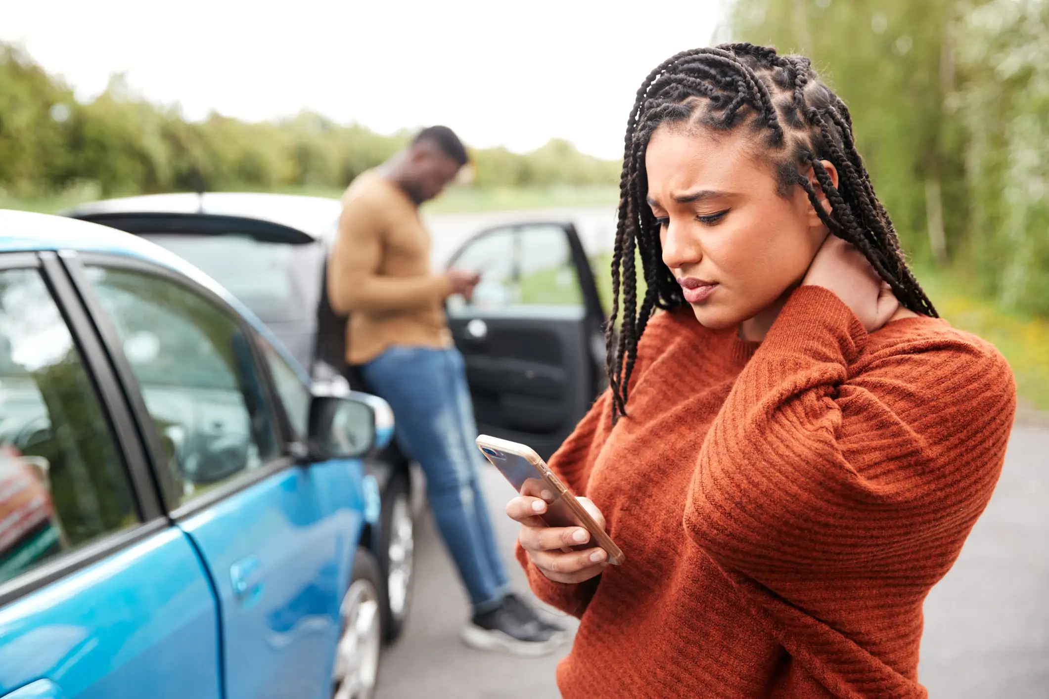Lady looking at her phone after a recent auto accident