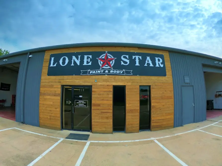 Collision repair technicians working on a vehicle at Lone Star Paint & Body in Lewisville, TX