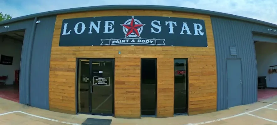 Exterior of Lone Star Paint & Body auto body shop with a large sign above the entrance