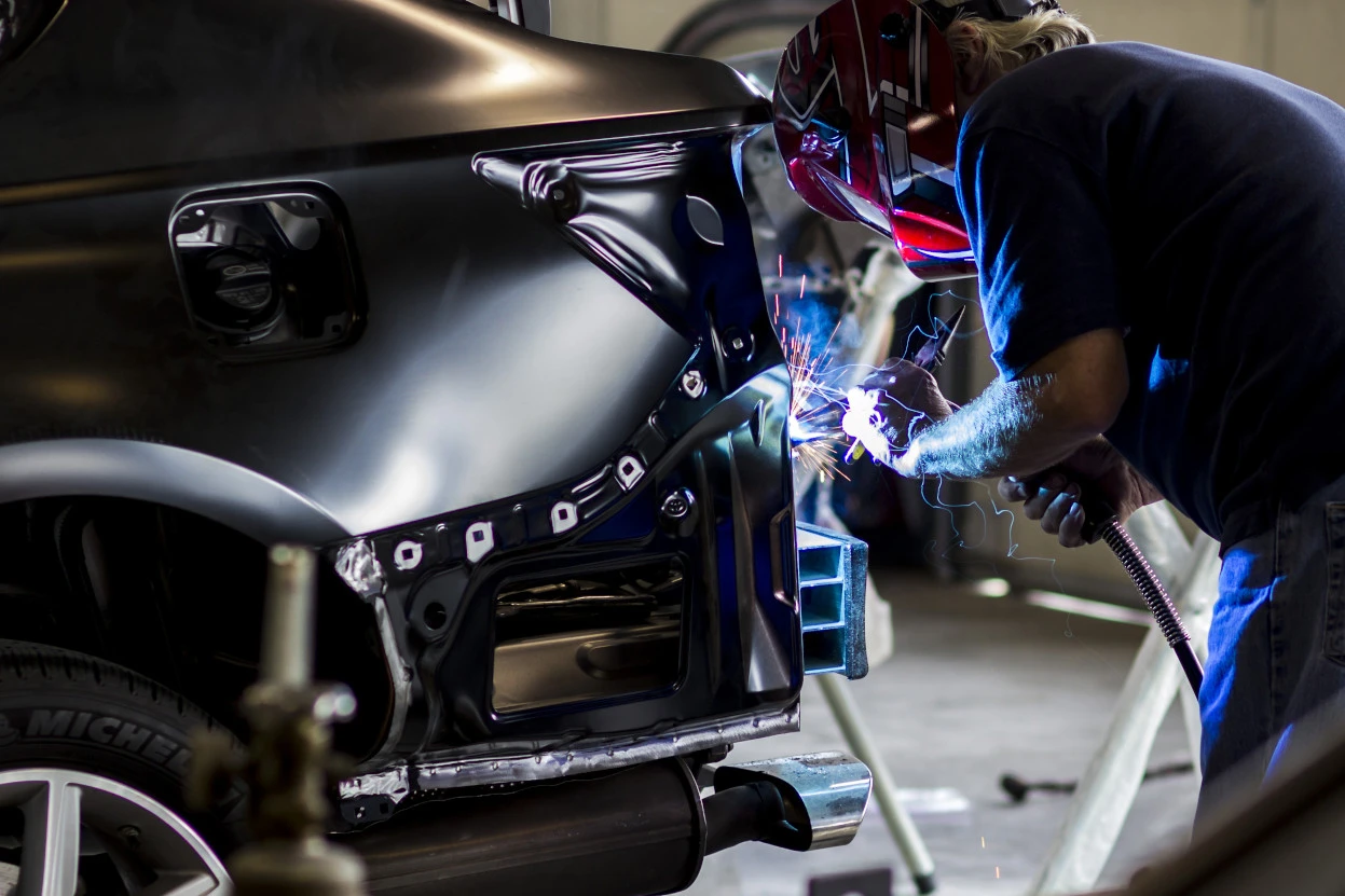 Auto body technician welding bumper in Lewisville TX
